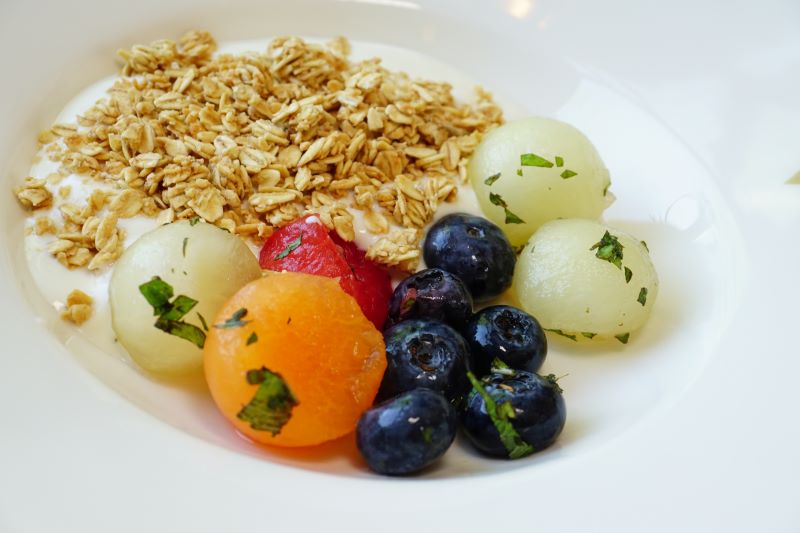 tricolour melon and fresh blueberry salad in a minted syrup with fresh natural yoghurt and a final flourish from the servers of seeded granola