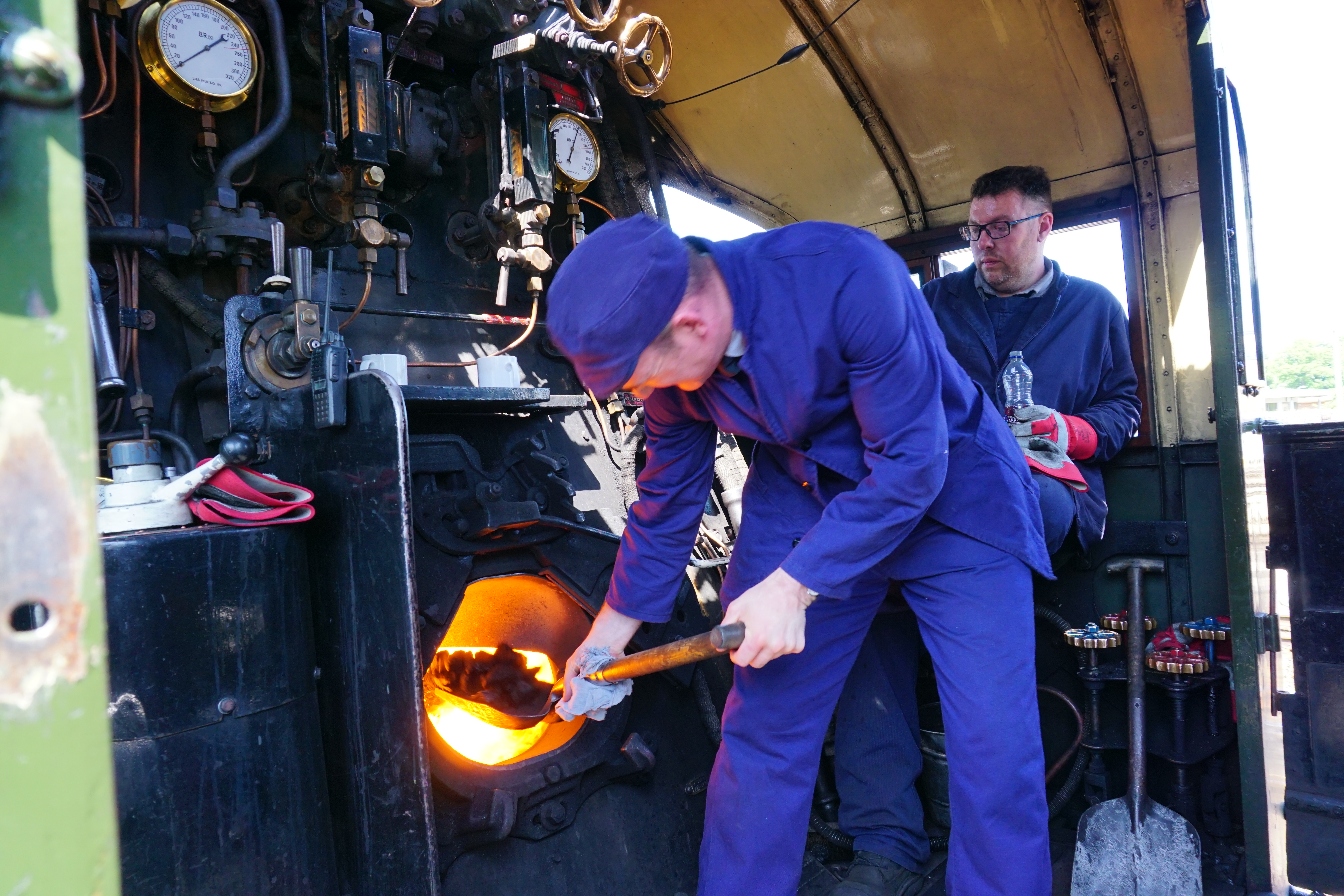 Keeping_Steam_Up_workers_add_coal_to_the_fire